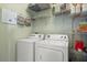 Functional laundry room includes washer, dryer, and convenient shelving for storage at 1530 Tally Cir, Oviedo, FL 32765