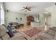 Open-concept living room with a comfortable seating area, ceiling fan, and access to the kitchen at 1530 Tally Cir, Oviedo, FL 32765