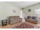 Cozy living room with neutral walls, seating, and a patterned rug on tile flooring at 1530 Tally Cir, Oviedo, FL 32765