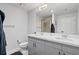 Bright bathroom with a double sink vanity, modern fixtures, and glass-enclosed shower at 155 S Court Ave # 1202, Orlando, FL 32801