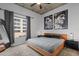 Modern bedroom with stylish art pieces, dark curtains and downtown view at 155 S Court Ave # 1202, Orlando, FL 32801