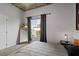 Cozy bedroom showcasing a comfortable bed, mirror, and window offering a city view at 155 S Court Ave # 1202, Orlando, FL 32801