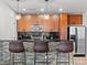 Modern kitchen featuring wooden cabinets, stainless steel appliances, black subway tile backsplash and bar seating at 155 S Court Ave # 1202, Orlando, FL 32801