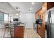 Modern kitchen featuring wooden cabinets, stainless steel appliances, and granite countertops at 155 S Court Ave # 1202, Orlando, FL 32801