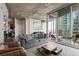 Spacious living room with large windows, modern decor, and access to the balcony at 155 S Court Ave # 1202, Orlando, FL 32801