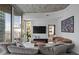 Comfortable living room with modern decor, concrete ceiling, and city views from the balcony at 155 S Court Ave # 1202, Orlando, FL 32801