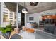 Open concept living room with kitchen, modern decor, and access to the balcony at 155 S Court Ave # 1202, Orlando, FL 32801