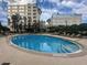 Stunning community pool surrounded by lounge chairs and lush landscaping, perfect for relaxation at 155 S Court Ave # 1202, Orlando, FL 32801