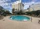 Beautiful community pool surrounded by lounge chairs and lush landscaping, perfect for relaxation at 155 S Court Ave # 1202, Orlando, FL 32801
