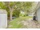 Spacious backyard with mature trees offering shade, storage shed, and play area at 157 Long Pine Dr, Deltona, FL 32725