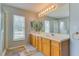 Bright bathroom features double sink vanity, large mirror with great lighting and walk-in shower at 157 Long Pine Dr, Deltona, FL 32725