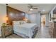 Comfortable bedroom with a rustic wood accent wall, pendant lights, and luxury vinyl plank flooring at 157 Long Pine Dr, Deltona, FL 32725