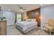 Comfortable bedroom with a rustic wood accent wall, pendant lights, and a ceiling fan at 157 Long Pine Dr, Deltona, FL 32725