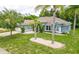 Charming home with a well-kept lawn, palm trees and a stone walkway at 157 Long Pine Dr, Deltona, FL 32725