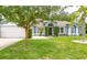 Charming single-story home with a lush green lawn, mature trees, and a well-manicured landscape at 157 Long Pine Dr, Deltona, FL 32725