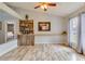 Bright living room with a bar area, built-in shelves, and ample natural light from a large window at 157 Long Pine Dr, Deltona, FL 32725
