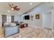 Bright living room featuring a modern ceiling fan, stylish furniture, and wood-look flooring at 157 Long Pine Dr, Deltona, FL 32725