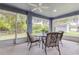 Relaxing screened-in porch featuring stylish outdoor seating, ceiling fan, and backyard view at 157 Long Pine Dr, Deltona, FL 32725