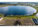 Expansive aerial shot of a property with lake views, highlighting its prime location and peaceful surroundings at 200 Valencia Ridge Dr, Auburndale, FL 33823
