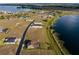 Beautiful aerial view of new construction homes near lakefront property and an expansive rural landscape at 200 Valencia Ridge Dr, Auburndale, FL 33823
