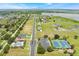 An aerial view of a neighborhood showing the community pool, sports courts, lake, and single-Gathering homes at 200 Valencia Ridge Dr, Auburndale, FL 33823