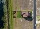 Real estate aerial view of new construction home with pond in backyard and street access at 200 Valencia Ridge Dr, Auburndale, FL 33823