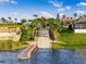 Aerial view of a boat ramp leading to a lake with a house in the background at 200 Valencia Ridge Dr, Auburndale, FL 33823