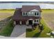 Stunning aerial view of a two-story home with a well-manicured lawn, showcasing its architectural design and curb appeal at 200 Valencia Ridge Dr, Auburndale, FL 33823