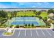 A view of the fenced-in basketball and tennis court with ample parking, overlooking a large lake at 200 Valencia Ridge Dr, Auburndale, FL 33823