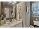 Powder room features quartz counters, framed mirror and decorative lighting at 200 Valencia Ridge Dr, Auburndale, FL 33823