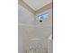 Modern bathroom shower features marble-look tile, decorative tile band and window with seat at 200 Valencia Ridge Dr, Auburndale, FL 33823