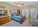 A charming bedroom with a four poster bed with blue bedding, neutral walls and carpeted floors at 200 Valencia Ridge Dr, Auburndale, FL 33823