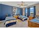 Charming bedroom with matching twin beds, complemented by a ceiling fan and a view through the window at 200 Valencia Ridge Dr, Auburndale, FL 33823