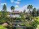 Community pool area featuring meticulously landscaped tiered gardens, a spacious pool, and abundant greenery at 200 Valencia Ridge Dr, Auburndale, FL 33823