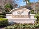 Entrance sign for WaterRidge community in an area filled with colorful flowers and lush greenery at 200 Valencia Ridge Dr, Auburndale, FL 33823