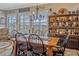 Dining room featuring a wooden table, chairs, large windows, and a decorative hutch at 200 Valencia Ridge Dr, Auburndale, FL 33823