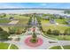 Aerial view of the community entrance, showing landscaped roundabout, gatehouse, and lake views at 200 Valencia Ridge Dr, Auburndale, FL 33823
