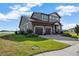 A beautifully landscaped two-story home featuring an attached three-car garage and a charming exterior at 200 Valencia Ridge Dr, Auburndale, FL 33823
