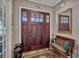 Welcoming foyer featuring a dark wood front door, bench, decorative rug and elegant decor at 200 Valencia Ridge Dr, Auburndale, FL 33823
