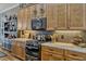 Well-equipped kitchen with granite countertops, custom cabinets, and modern stainless steel appliances at 200 Valencia Ridge Dr, Auburndale, FL 33823