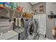 Modern laundry room with stainless steel washer and dryer, storage shelves, and stylish decor at 200 Valencia Ridge Dr, Auburndale, FL 33823