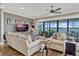 Open living room with waterfront views, comfortable seating, and modern ceiling fan at 200 Valencia Ridge Dr, Auburndale, FL 33823