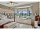 Elegant bedroom featuring a canopy bed, window seat and scenic views of the lake at 200 Valencia Ridge Dr, Auburndale, FL 33823