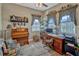 Cozy home office boasts an upright piano, desk and chair, and lots of natural light at 200 Valencia Ridge Dr, Auburndale, FL 33823