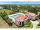 An aerial view of a community pool with a clubhouse, surrounded by lush landscaping and a black metal fence at 200 Valencia Ridge Dr, Auburndale, FL 33823