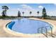 Large swimming pool with ladder steps and plenty of sunbathing space at 200 Valencia Ridge Dr, Auburndale, FL 33823