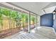 Covered porch with wood flooring offers a view of bamboo plants along a fence at 2004 E Marks St, Orlando, FL 32803