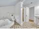 Bright bathroom features a vintage clawfoot tub, tile floor, and a walk-in shower at 2004 E Marks St, Orlando, FL 32803