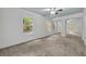 Spacious bedroom with large windows, a ceiling fan, and mirrored closet doors at 2004 E Marks St, Orlando, FL 32803