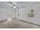 Well-lit bedroom with a ceiling fan, carpet flooring, and natural light from exterior views at 2004 E Marks St, Orlando, FL 32803